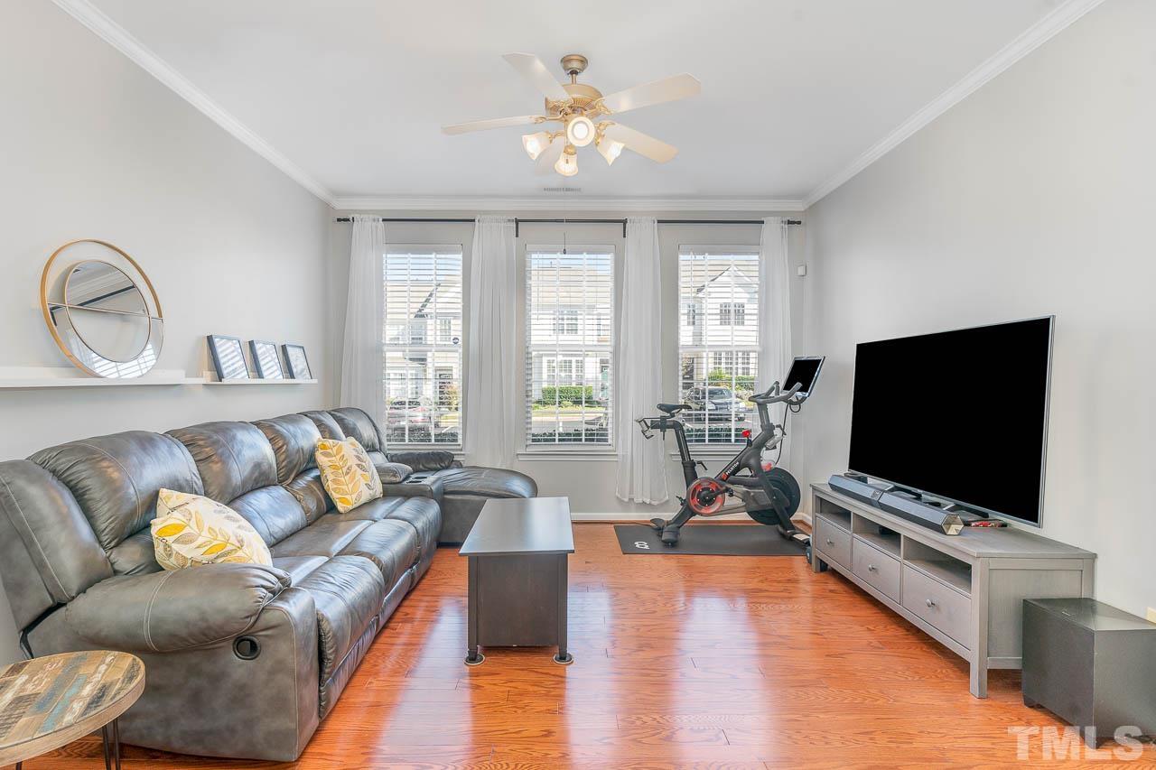 7859 Silverthread Lane Raleigh, NC 27617 - Photo 10 of 25 a living room with furniture and a flat screen tv