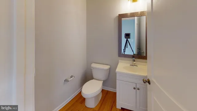 a white toilet sitting next to a bathroom sink