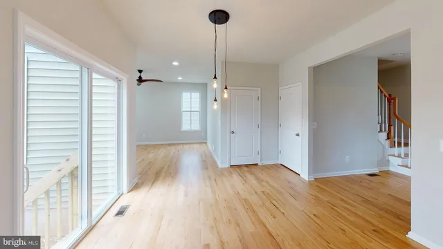 a view of hallway with wooden floor