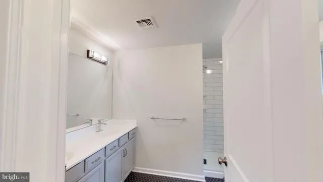a bathroom with a double vanity sink and mirror