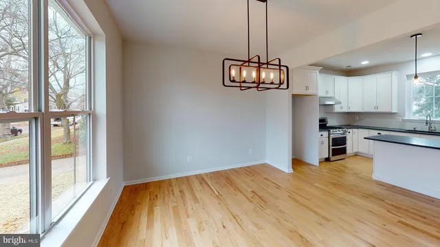 a view of a kitchen with wooden floor and a window