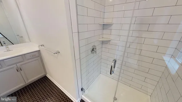 a bathroom with a granite countertop shower