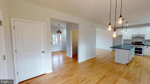 a view of kitchen with furniture and wooden floor