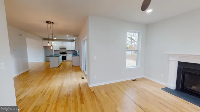 a view of a kitchen and an empty room