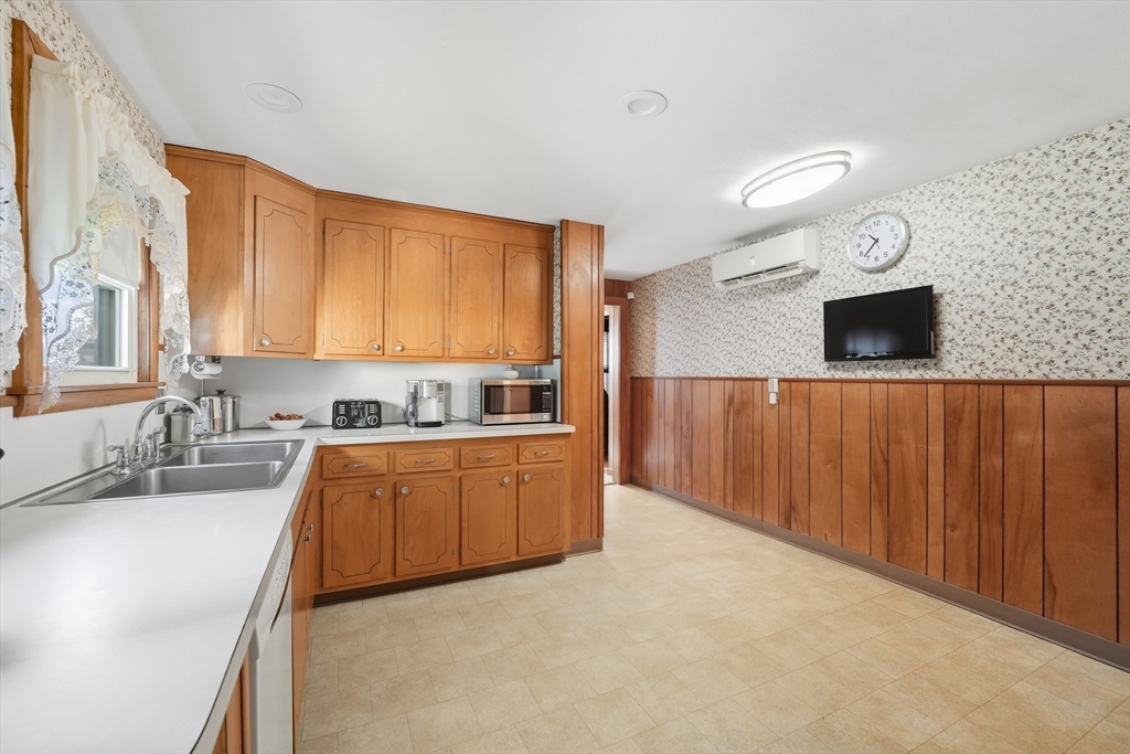 30 Athol Street Springfield, MA 01107 - Photo 11 of 38 a kitchen with stainless steel appliances granite countertop a sink a stove and a microwave