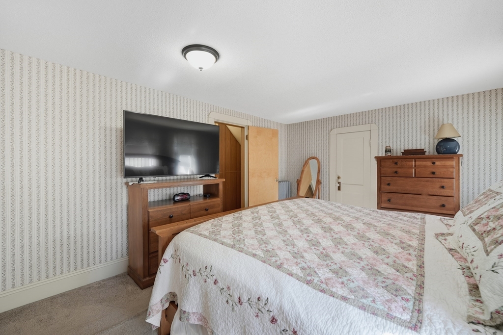 30 Athol Street Springfield, MA 01107 - Photo 16 of 38 a bedroom with a bed and a flat screen tv