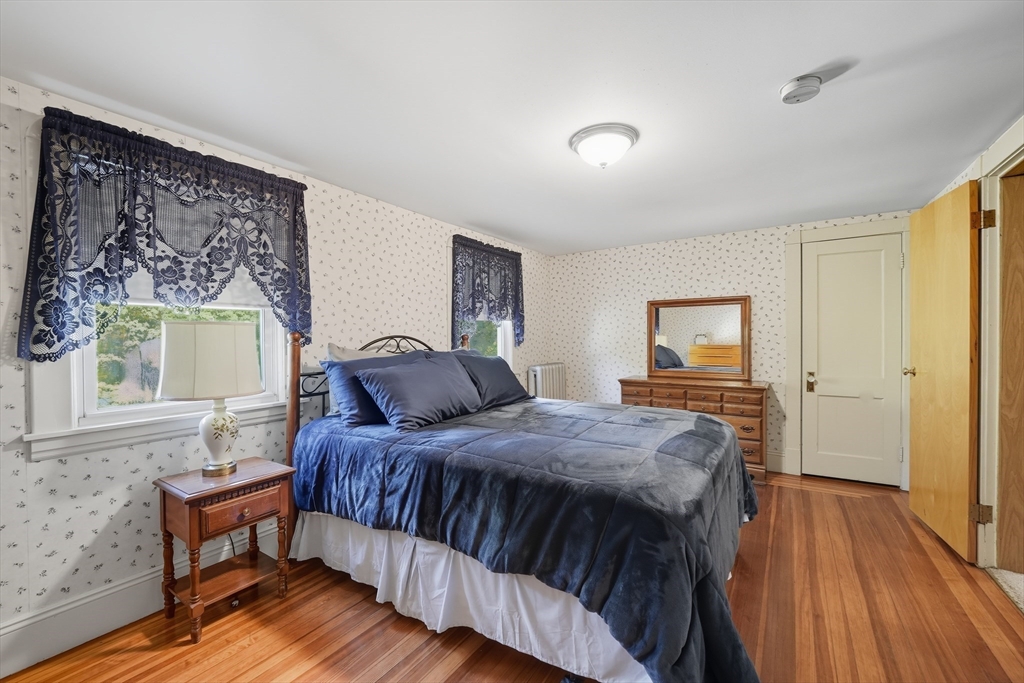 30 Athol Street Springfield, MA 01107 - Photo 19 of 38 a bedroom with a bed and wooden floor