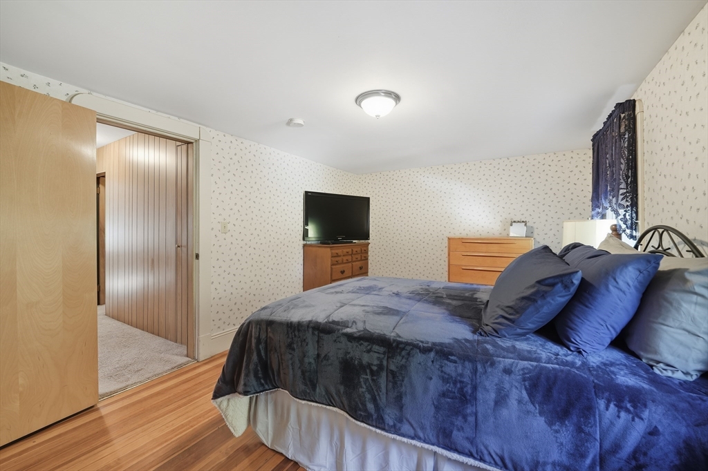 30 Athol Street Springfield, MA 01107 - Photo 20 of 38 a bedroom with a bed and a flat screen tv