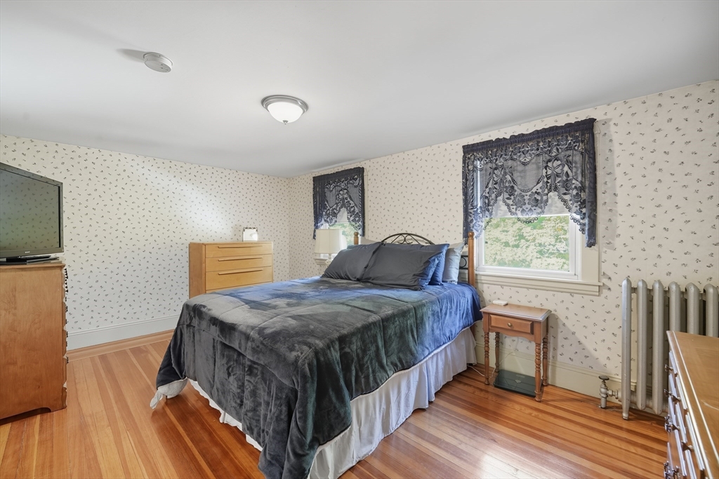 30 Athol Street Springfield, MA 01107 - Photo 21 of 38 a bedroom with a bed next to a window