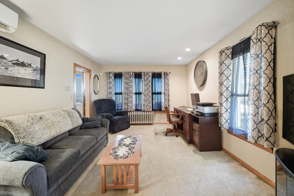 30 Athol Street Springfield, MA 01107 - Photo 4 of 38 a living room with furniture fireplace and a large window
