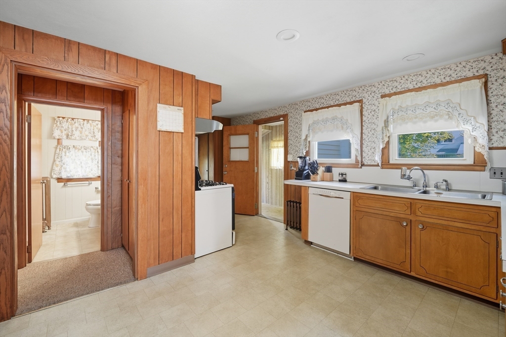 30 Athol Street Springfield, MA 01107 - Photo 8 of 38 a large white kitchen with a sink a refrigerator and window