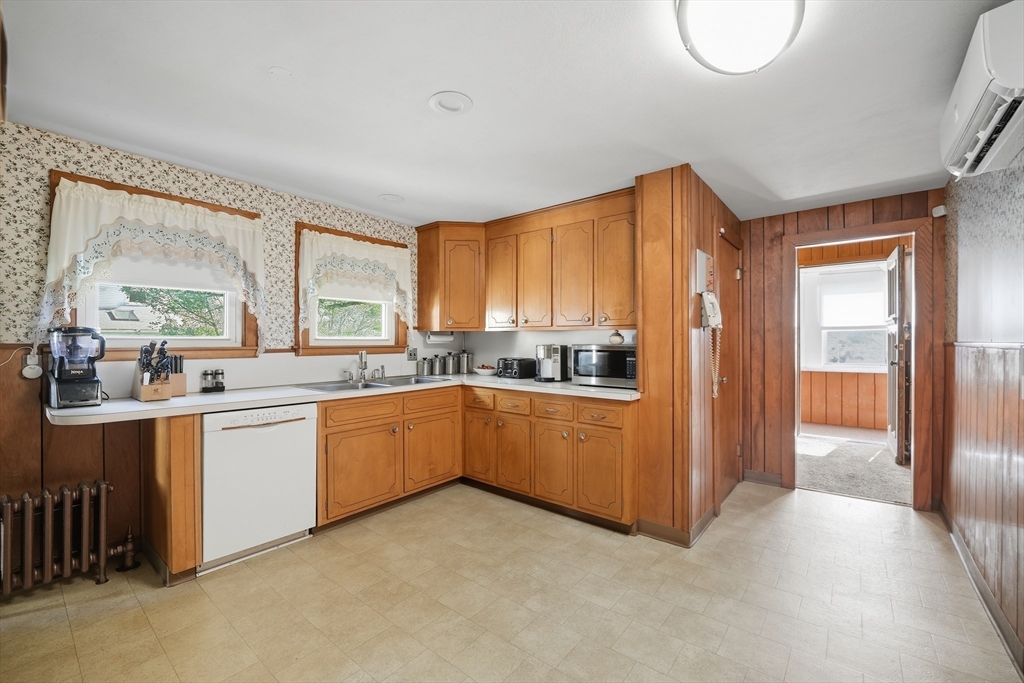 30 Athol Street Springfield, MA 01107 - Photo 10 of 38 a kitchen with stainless steel appliances granite countertop a refrigerator a sink dishwasher a stove and a dining table with wooden cabinet