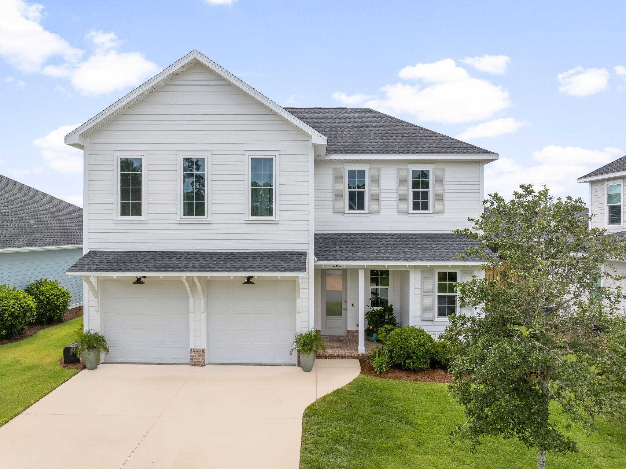 290 Windrow Way Watersound, FL 32461 - Photo 3 of 43 a front view of a house with a yard and garage