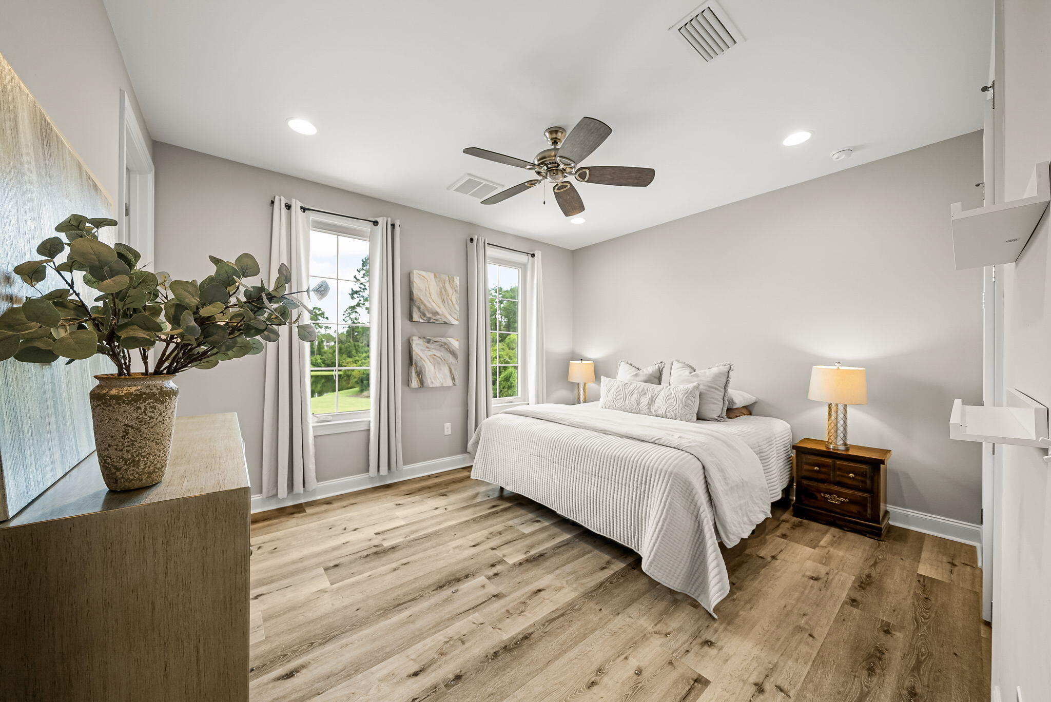 290 Windrow Way Watersound, FL 32461 - Photo 34 of 43 a spacious bedroom with a bed and a potted plant