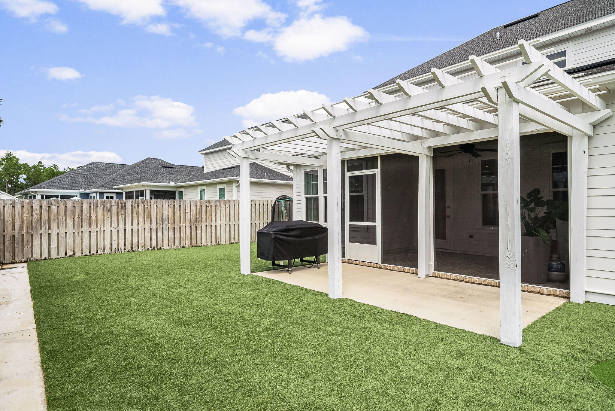 290 Windrow Way Watersound, FL 32461 - Photo 40 of 43 a view of a house with backyard porch and wooden fence