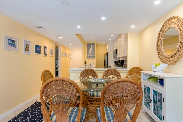 a view of a balcony with chairs and potted plants