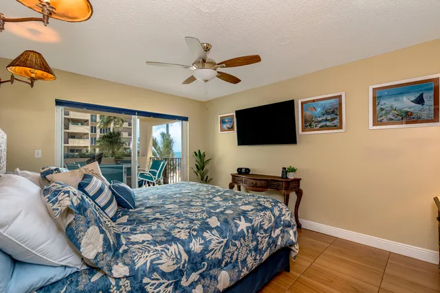 a view of swimming pool from a balcony with furniture