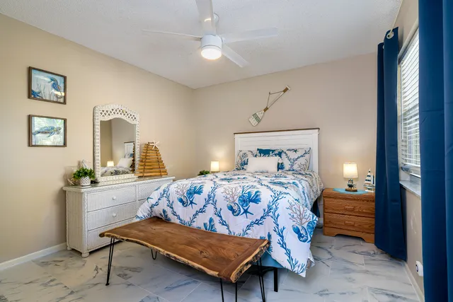 a bathroom with a granite countertop toilet sink and mirror