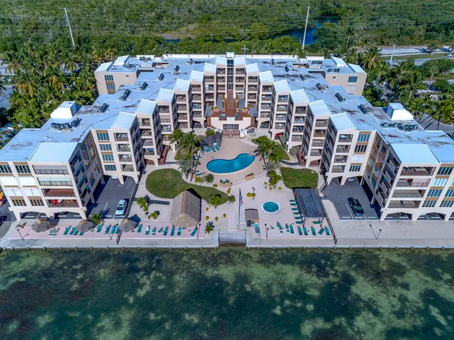 a view of a patio with table and chairs with wooden floor and plants