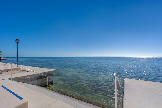 a view of a swimming pool with outdoor seating