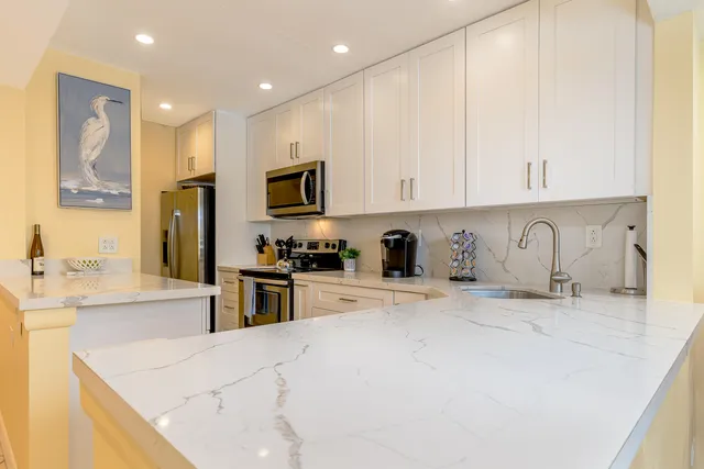 a kitchen with stainless steel appliances granite countertop a sink and cabinets
