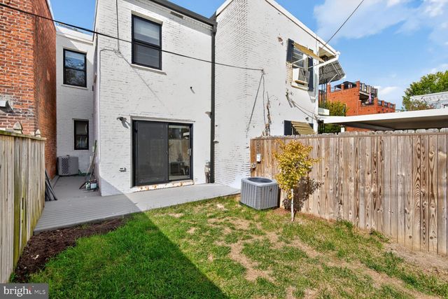 a view of a patio with table and chairs and potted plants