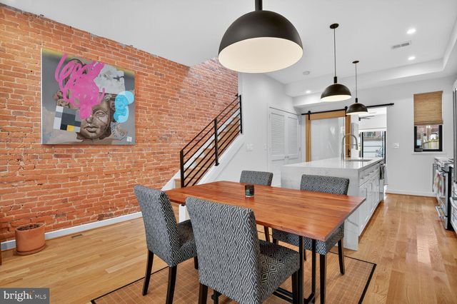 a dining room with furniture a rug and wooden floor