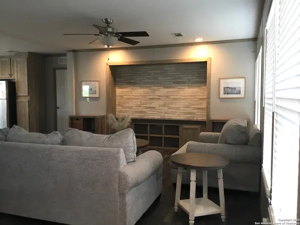 a living room with furniture a dining table and a fireplace