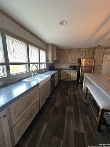 a kitchen with sink cabinets and window