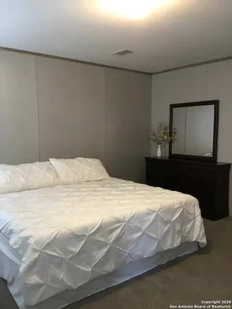 a bedroom with a bed and a mirror