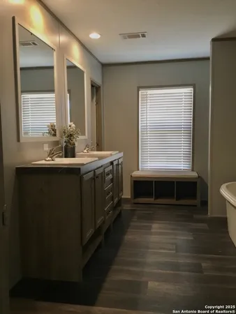a bathroom with a sink and a window