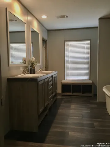 a bathroom with a sink and a window