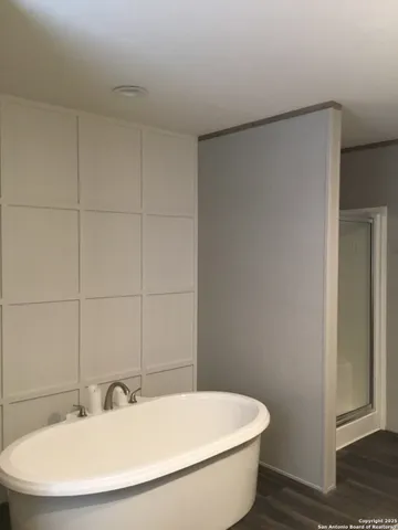 a white bath tub sitting next to a white sink