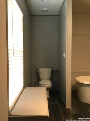 a bathroom with a toilet and a sink