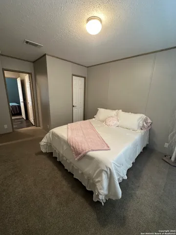 a bedroom with a bed and a mirror