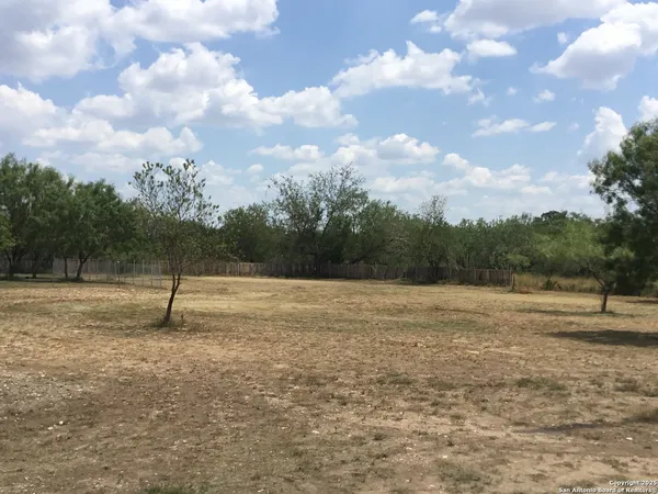 a view of outdoor space with swimming pool and trees in the background