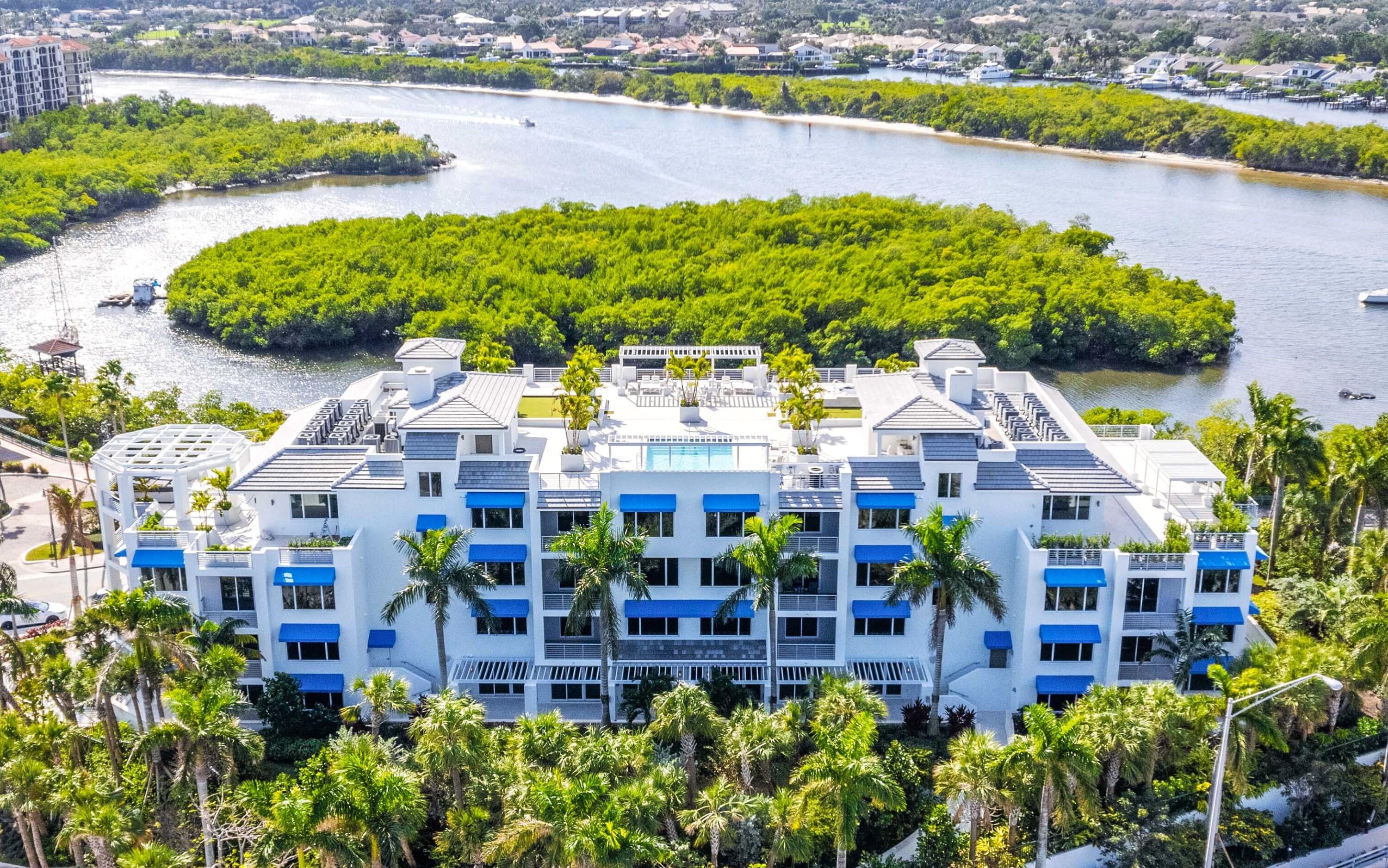 a aerial view of a house with a garden and lake view