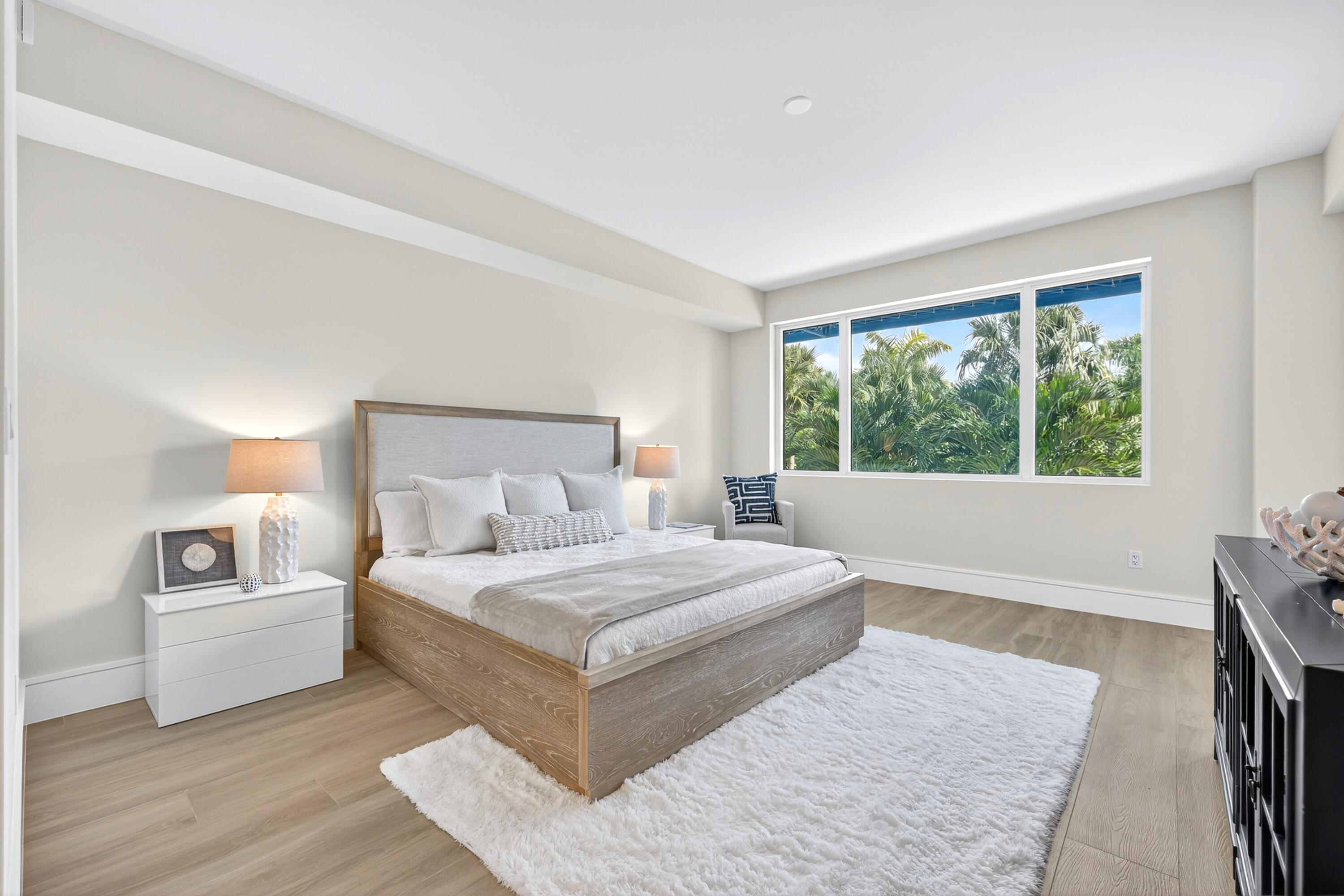 1 South Coastal Way, Unit 3030 Jupiter, FL 33477 - Photo 22 of 61 a bedroom with a large bed and a large window