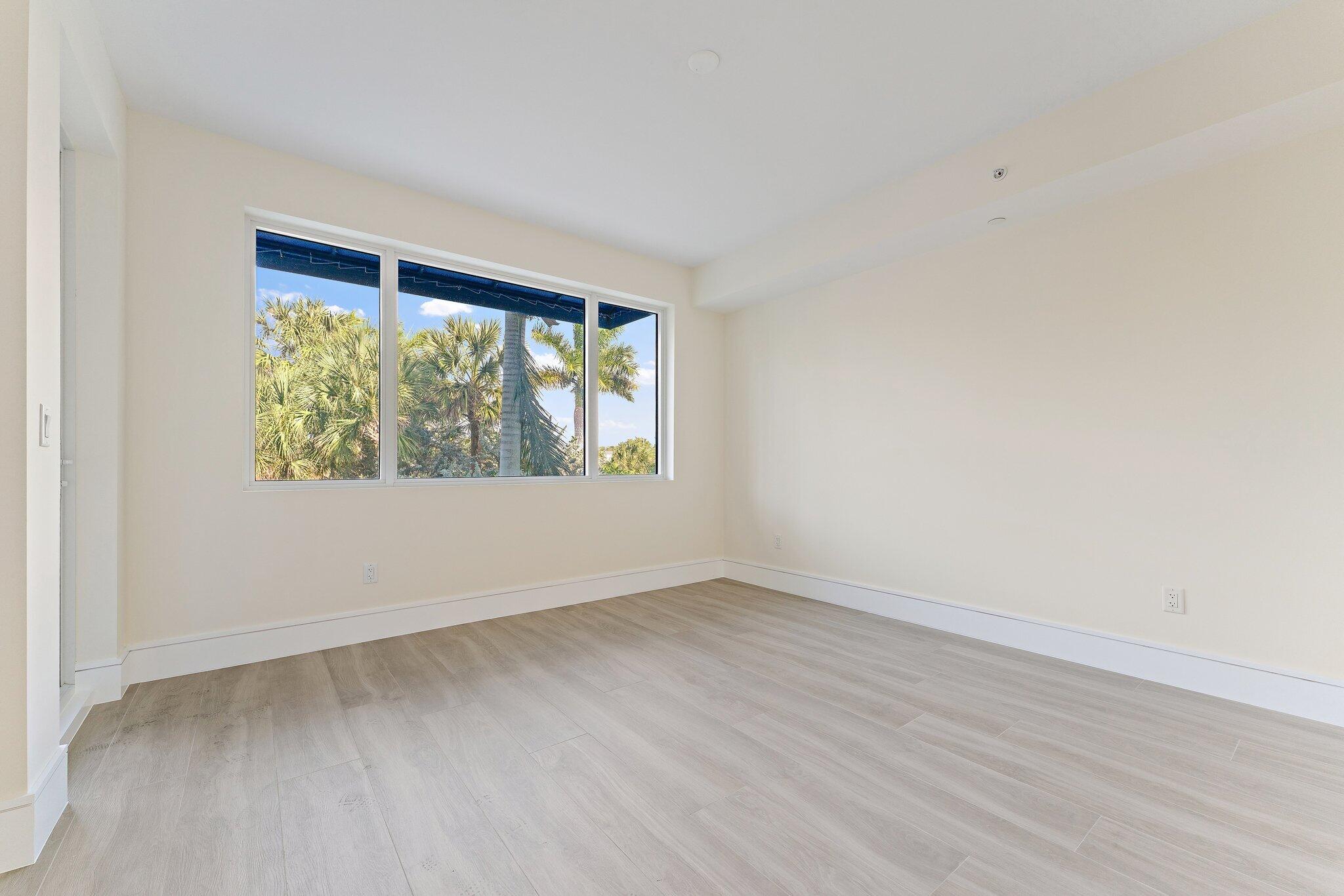 1 South Coastal Way, Unit 3030 Jupiter, FL 33477 - Photo 25 of 61 an empty room with wooden floor and windows