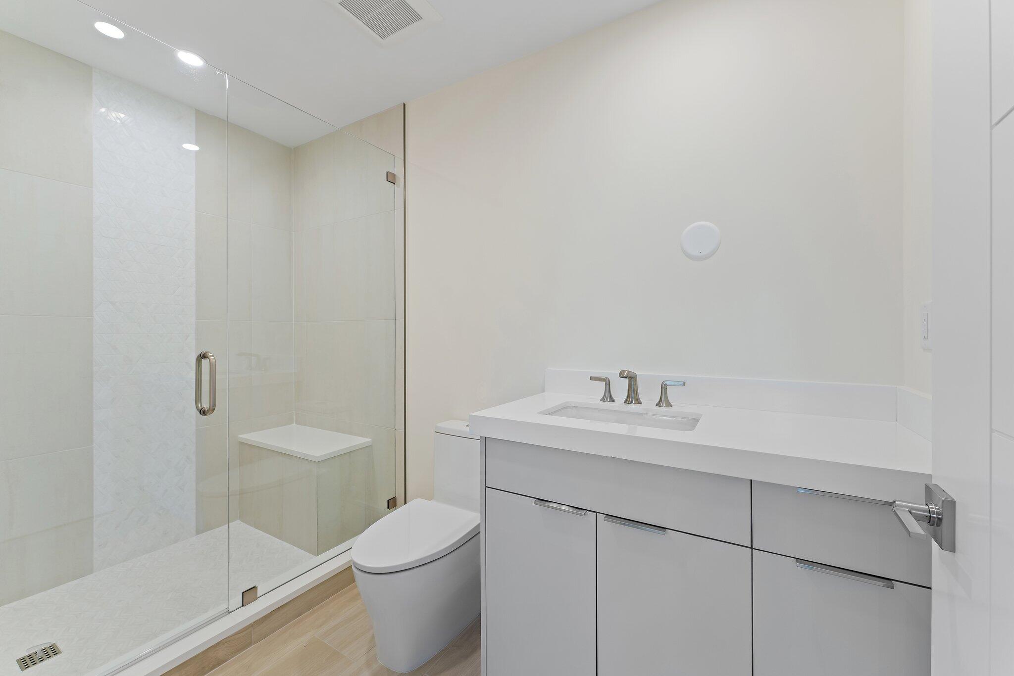 1 South Coastal Way, Unit 3030 Jupiter, FL 33477 - Photo 26 of 61 a bathroom with a toilet a sink a mirror and vanity