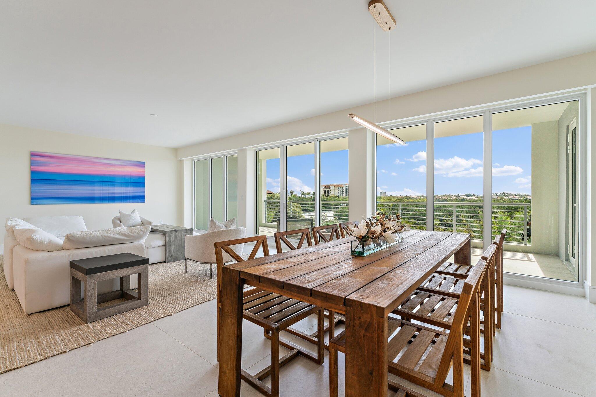 1 South Coastal Way, Unit 3030 Jupiter, FL 33477 - Photo 9 of 61 a view of a dining room with furniture large windows and wooden floor