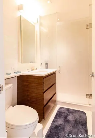 a bathroom with a sink a toilet and mirror