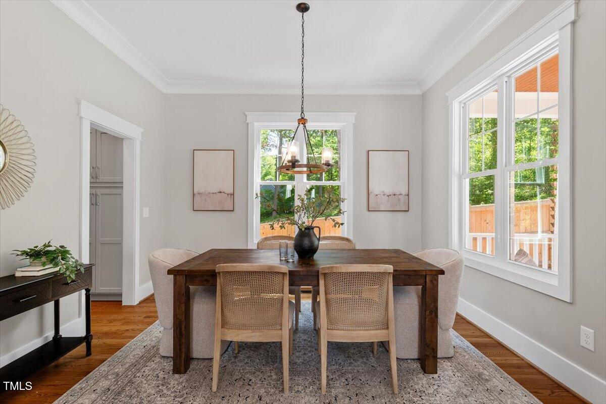 3932 Old Chapel Hill Road Durham, NC 27707 - Photo 13 of 46 a dining room with furniture a chandelier and wooden floor