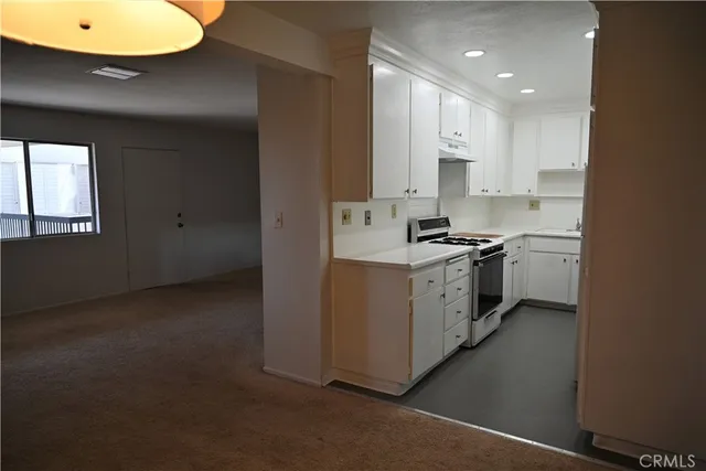 a kitchen with stainless steel appliances a sink stove and cabinets