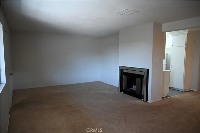 a view of empty room with a fireplace