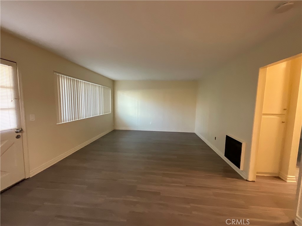 6042 Lime Avenue, Unit B Cypress, CA 90630 - Photo 11 of 20 a view of an empty room with wooden floor and a window