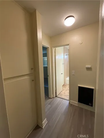 a view of a hallway with wooden floor and staircase