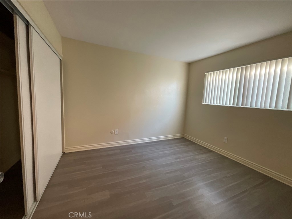 6042 Lime Avenue, Unit B Cypress, CA 90630 - Photo 17 of 20 an empty room with wooden floor and windows