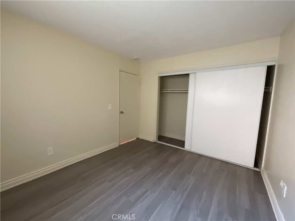 6042 Lime Avenue, Unit B Cypress, CA 90630 - Photo 19 of 20 a view of an empty room with wooden floor and a window