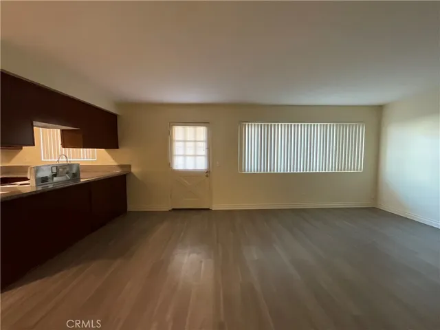 a view of wooden floor and windows in a room
